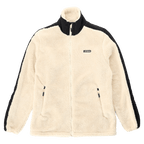 Veste polaire Teddy BVB de couleur crème, avec des éléments noirs dans un style « color block », manches longues, vue de face avec fermeture éclair et logo du Borussia Dortmund.