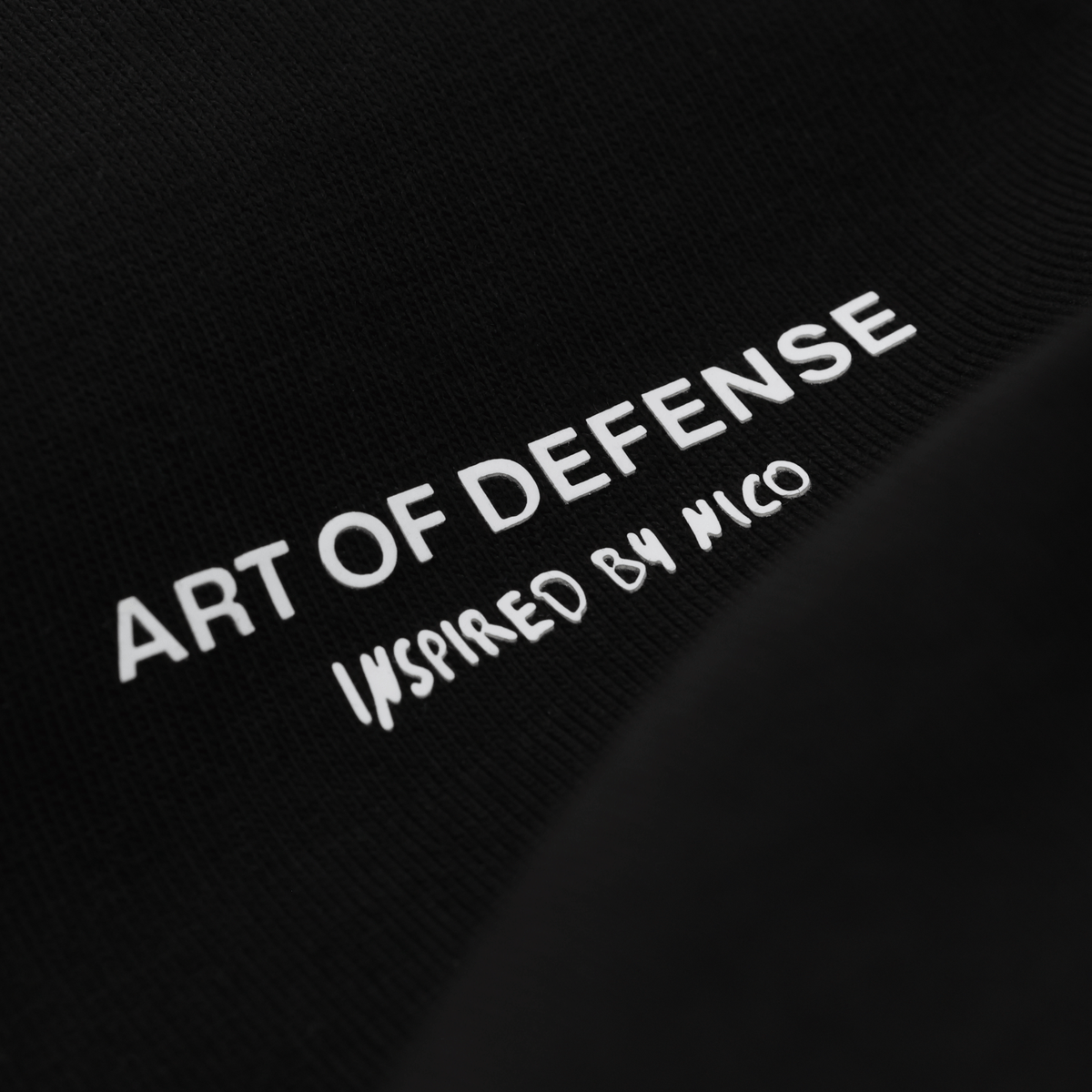 Camiseta negra del BVB con la inscripción en blanco «Art of Defense - Inspired by Nico», ideal para los aficionados del Borussia Dortmund.
