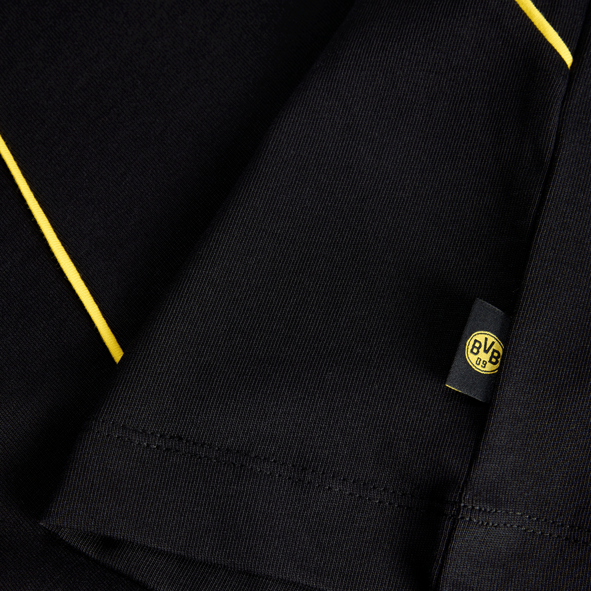 Close-up of a black-and-yellow BVB T-shirt with the BVB logo on a sewn-on label.