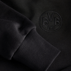 Close-up of the black BVB Hoodie Essentials II for kids, featuring the BVB logo, comfortable fabric, and cuffs on the sleeves.