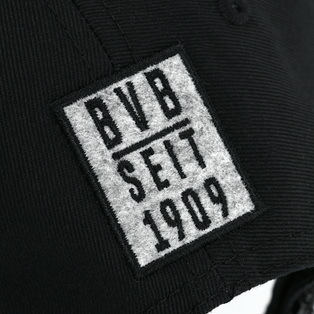 Cappellino nero del BVB con toppa in feltro grigio recante la scritta "BVB Seit 1909". Ideale per i tifosi del Borussia Dortmund.