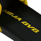 Black-and-yellow BVB bath slippers for kids, with a black insole featuring yellow "Heja BVB" lettering—perfect as fan merchandise or a summer accessory.