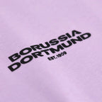 Lila BVB-T-Shirt mit schwarzem Borussia Dortmund-Schriftzug und Est. 1909, detailreiche Nahansicht des Motivs.
