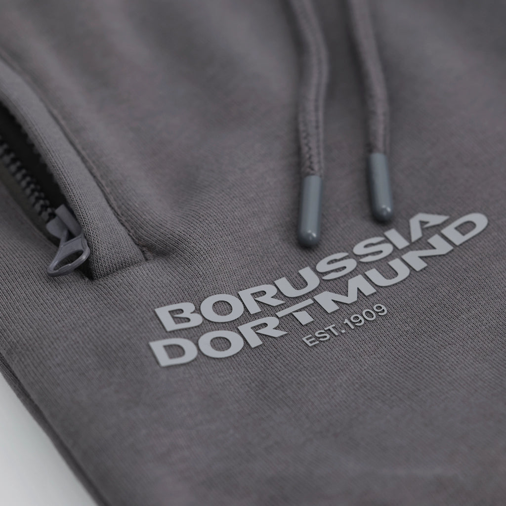 Graue BVB Urban Sweatpants mit Borussia Dortmund-Logo und Kordelzug, Detailaufnahme.