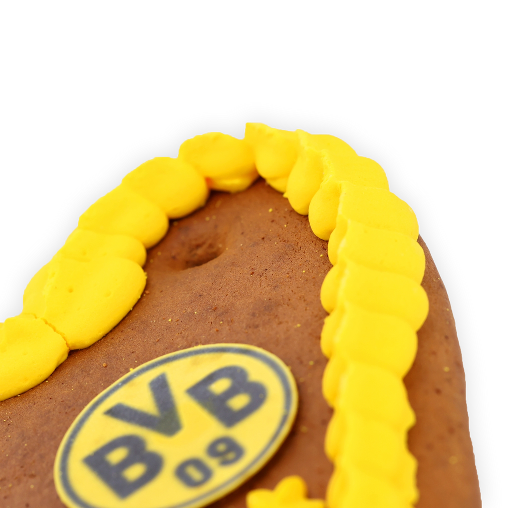 Corazón de pan de jengibre de 80 g con diseño en negro y amarillo, con el logotipo del BVB 09 y un ribete de glaseado amarillo.