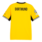 Das Bild zeigt die Rückseite des gelben BVB-Heimtrikots der Saison 2026/2027 mit schwarzem DORTMUND-Schriftzug und UEFA-Badge am Ärmel.
