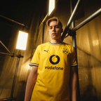 一位模特展示了2026/27赛季多特蒙德（BVB）主场正版球衣，球衣为黄色，配有黑色Puma标志、BVB队徽和Vodafone标志。