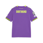 Vue de dos du maillot alternatif violet du BVB 26-27 pour enfants, avec l'inscription « DORTMUND », l'écusson de l'UEFA Champions League et le logo PUMA.