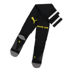 Chaussettes noires du BVB avec l'inscription « BVB 09 » en jaune et le logo PUMA, rayures blanches sur le haut des chaussettes, idéales pour les supporters du Borussia Dortmund.