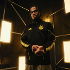 Black-and-yellow BVB King Anthem jacket from the 2026/27 season featuring the BVB 09 emblem and the PUMA logo, shown from the front on a model.