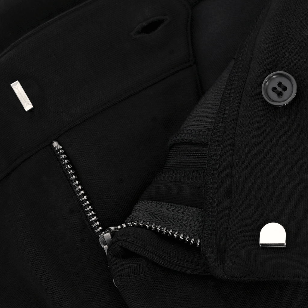 Gros plan sur le pantalon de sport BVB INBY III noir, doté d'une fermeture à glissière et d'un bouton aux détails soignés.