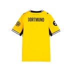 A view of the back of the yellow BVB 26-27 home jersey for kids and women's soccer from the 26-27 season, featuring "DORTMUND" lettering on the back, black accents, and logos on both sleeves.