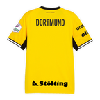 Camiseta amarilla del BVB para los partidos en casa de la temporada de balonmano 26/27, vista desde atrás, con el texto «DORTMUND» en negro y cuello negro.
