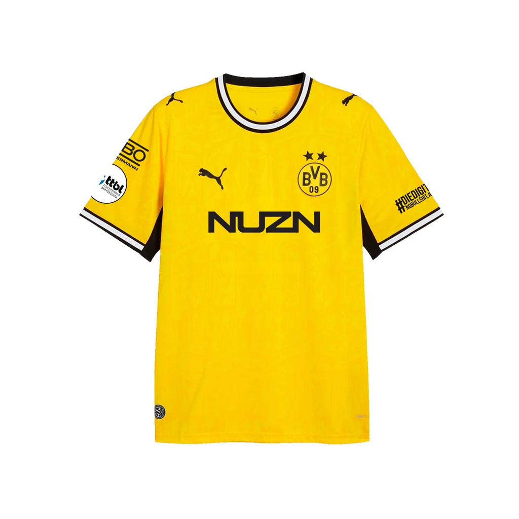Camiseta de local del BVB de la temporada 26-27, en negro y amarillo, para niños, de manga corta, con el logotipo de Puma, el escudo del BVB y los logotipos de los patrocinadores; vista frontal.