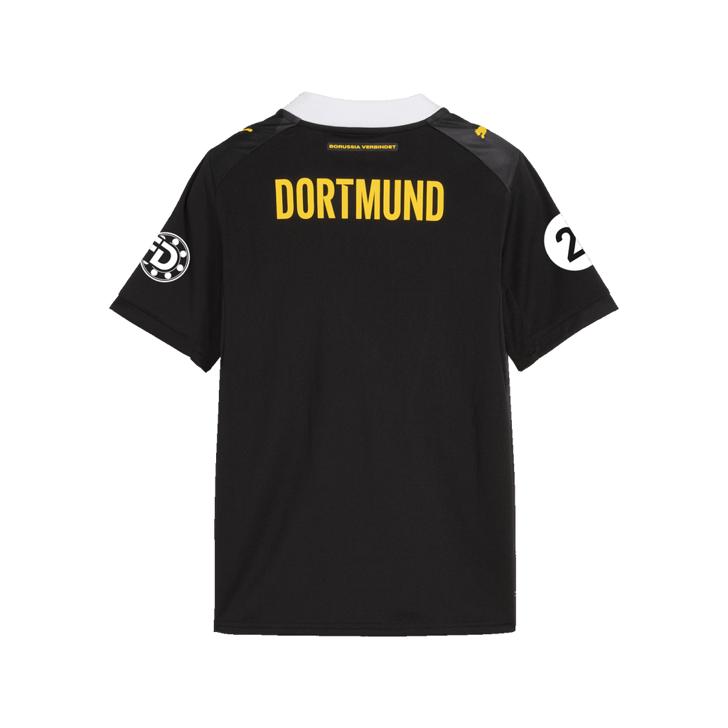 The photo shows the back of the black-and-yellow BVB 26-27 away jersey for girls' soccer, featuring the "DORTMUND" lettering and the Puma logo.