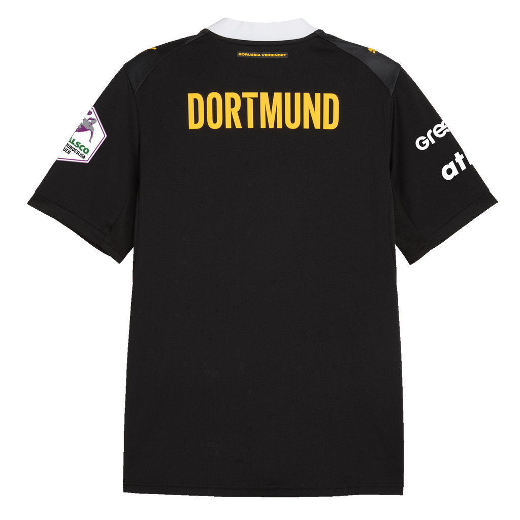 Vista posteriore della maglia da trasferta del BVB, nei colori nero e giallo, per la stagione di pallamano 2026-2027, con la scritta “DORTMUND” in giallo, i loghi degli sponsor in bianco e il fondo nero.